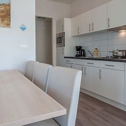 Modern kitchen and dining area in Chalet in Bredene, Belgian coast, ideal vacation home for a relaxing stay in Belgium.