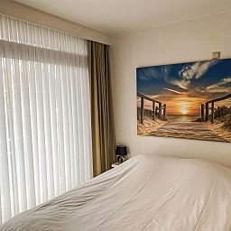 Attractive bedroom in Apartment 103, Bredene with coastal view painting, Belgian coast, ideal vacation accommodation.