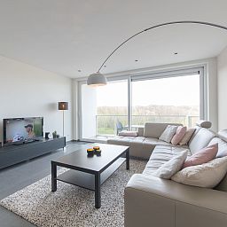 Cozy living room of Apartment Solis in Bredene, Belgian coast, with modern decor and views of nature.