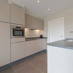 Modern kitchen in Apartment Solis, Bredene, Belgian coast. Enjoy a stylish cooking space during your stay in this vacation apartment.
