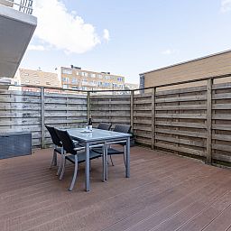 Enjoy the spacious terrace at Apartment Residentie Zandloper in Bredene, Belgian coast, ideal for relaxed outdoor dining.