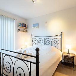 Cozy bedroom in Apartment Residentie Zandloper, Bredene, Belgian coast. Comfortable furnishings for a relaxing stay.