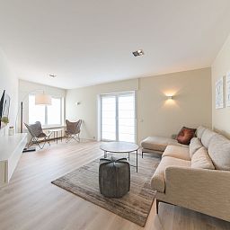 Stylish living room in Apartment Alaska Beach, Bredene, Belgian coast. Comfortable sitting area with lots of natural light and modern decor.