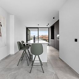 Modern kitchen in Penthouse 'Ter Elst', a luxury apartment in De Panne on the Belgian coast with a view of the city.