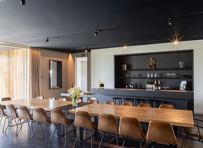 AKKERNEST vacation home in Heuvelland with colorful flower meadow and solar panels in West Flanders, Belgium.