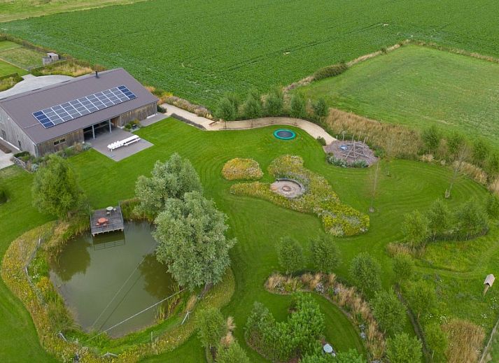 Spacious dining room in AKKERNEST vacation home, Hill Country, with long table and modern bar facilities.