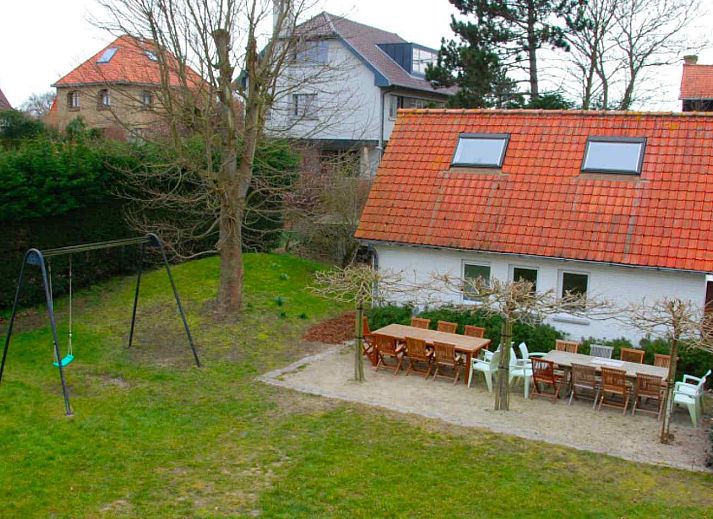 Front view of vacation home BK038 in Koksijde, West Flanders, with charming facade and green surroundings.