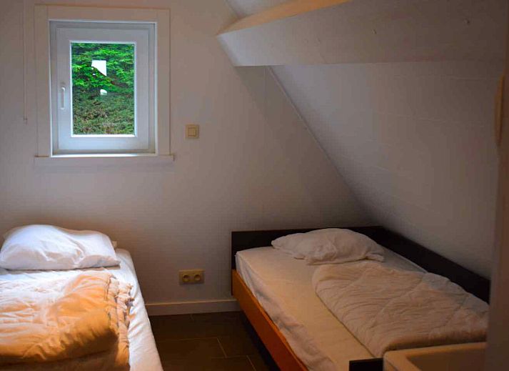 Cozy living room in vacation home BK038, Koksijde, West Flanders, with comfortable sitting area and warm furnishings.