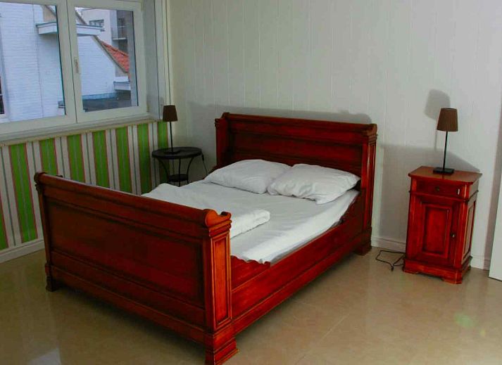 Bedroom with bunk bed in vacation home BK038, Koksijde, West Flanders, overlooking quiet neighborhood.