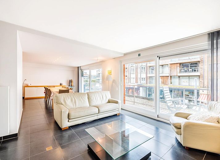 Spacious living room of Brit First vacation home in Koksijde, West Flanders, with modern furnishings and large windows for plenty of natural light.