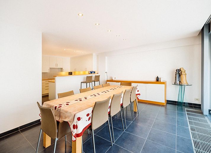 Spacious dining and living room of vacation home Brit First in Koksijde, West Flanders, with modern interior and city views.