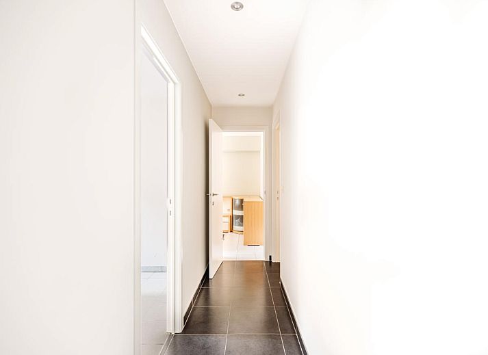 Spacious dining and living room of vacation home Brit First in Koksijde, West Flanders, with modern interior and city views.