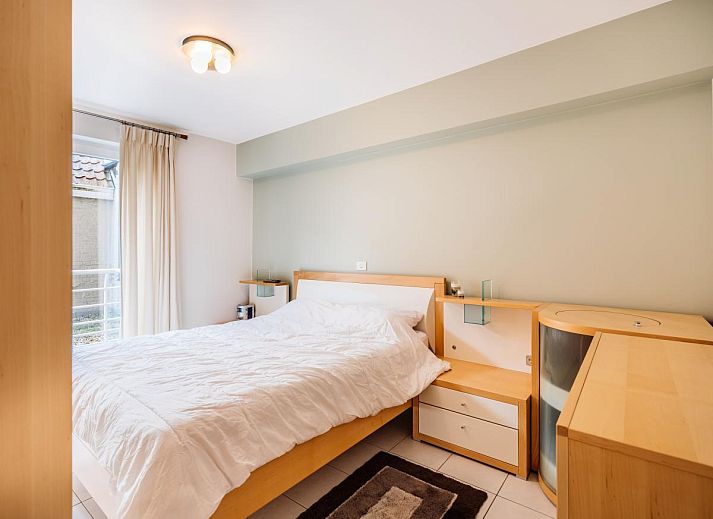 Veranda of Brit First vacation home in Koksijde, West Flanders overlooking charming street and sea in the distance.