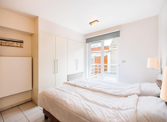 Veranda of Brit First vacation home in Koksijde, West Flanders overlooking charming street and sea in the distance.