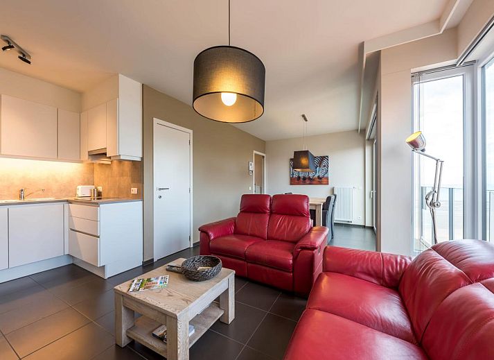 Gezellige woonkamer in vakantiehuis De Dijk zesde, Koksijde, met moderne inrichting en uitzicht op de stad West-Vlaanderen, Belgie.