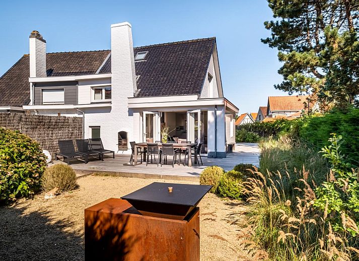 Gezellige eetkamer in Tranquil vakantiehuis, Koksijde, met uitzicht op de tuin, ideaal voor een ontspannen verblijf in West-Vlaanderen, Belgie.