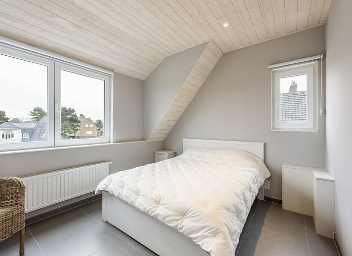 Stylish kitchen and dining area in La Vachequirit vacation home, Koksijde, West Flanders, overlooking a quiet residential area.