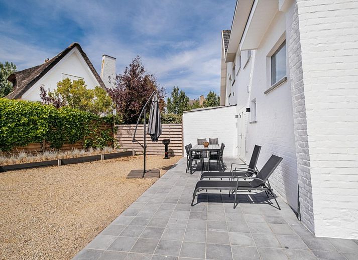 Stylish kitchen and dining area in La Vachequirit vacation home, Koksijde, West Flanders, overlooking a quiet residential area.