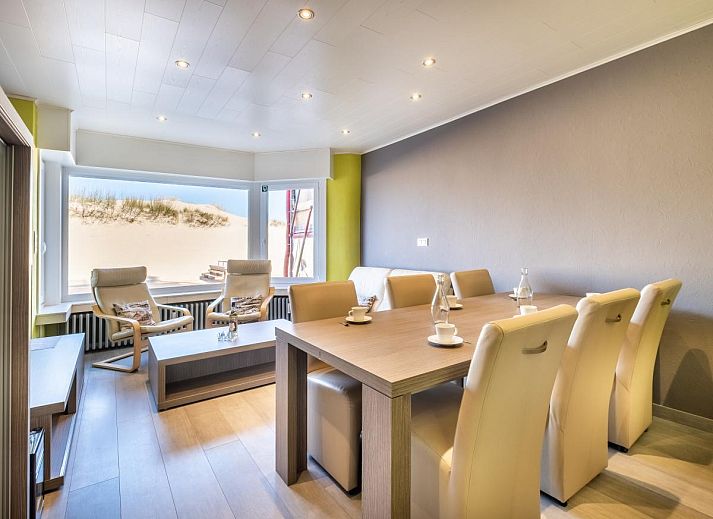 Stijlvol ingerichte woonkamer van vakantiehuis Zeezicht GV in Koksijde, West-Vlaanderen met uitzicht op de duinen.