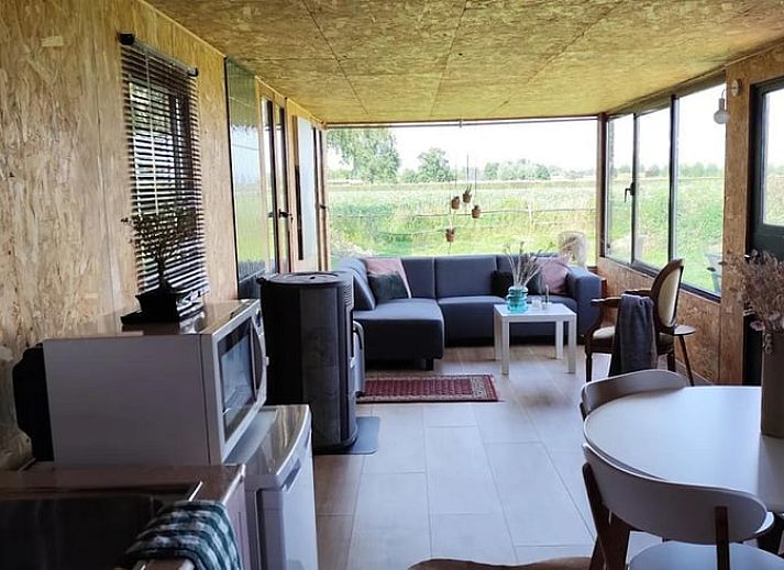 Cozy porch of Holiday Home in Zarren overlooking green fields in West Flanders, Belgium.
