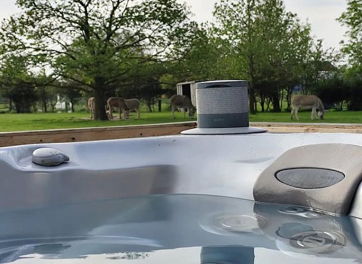 Cozy porch of Holiday Home in Zarren overlooking green fields in West Flanders, Belgium.