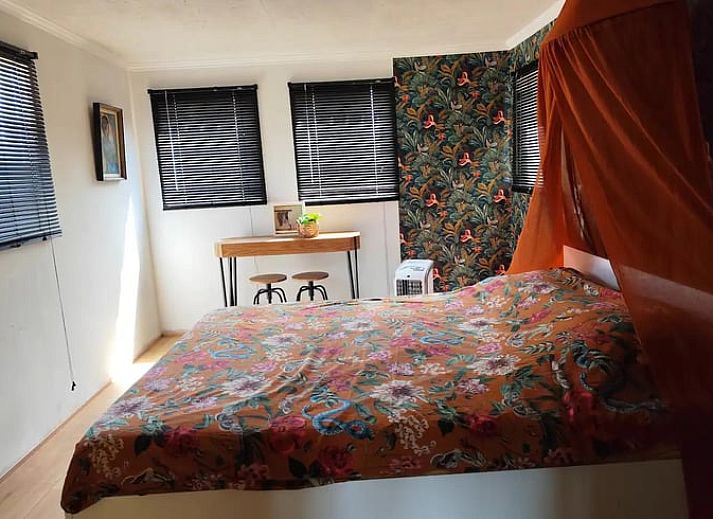 Cozy porch of Holiday Home in Zarren overlooking green fields in West Flanders, Belgium.