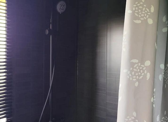 Rustic terrace with seating surrounded by nature at Holiday home in Zarren, West Flanders, Belgium.