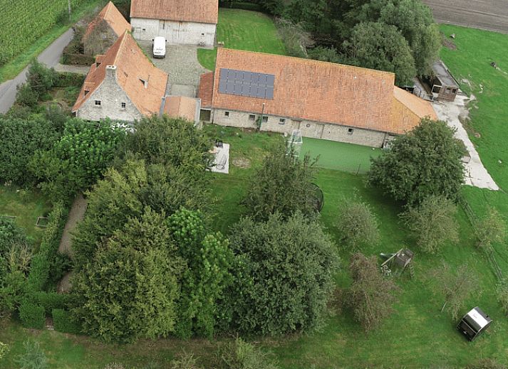 Rustic terrace with seating surrounded by nature at Holiday home in Zarren, West Flanders, Belgium.