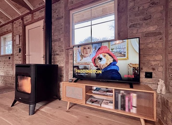 Cozy kitchen in Cottage in Alveringem, cottage in West Flanders, Belgium with rustic brick walls and modern amenities.