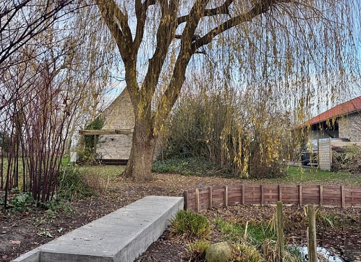 Cozy living room of Cottage in Alveringem, vacation home in West Flanders, with wood stove and television for ultimate relaxation.