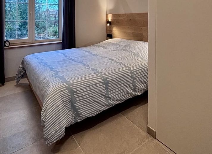 Cozy living room of Cottage in Alveringem, vacation home in West Flanders, with wood stove and television for ultimate relaxation.