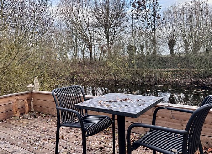 Cozy living room of Cottage in Alveringem, vacation home in West Flanders, with wood stove and television for ultimate relaxation.