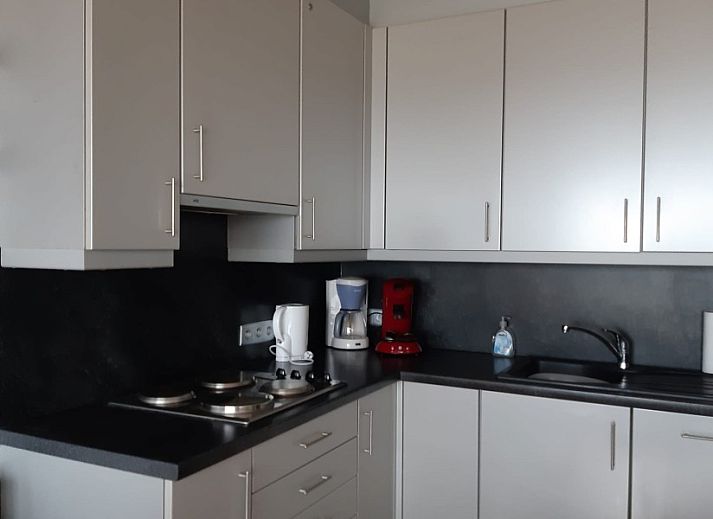 Exterior of Ramses studio apartment in De Panne, Belgian coast, next to a characteristic building.