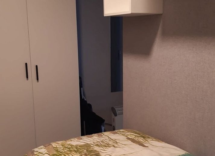 Front of Ramses studio apartment in De Panne, Belgian coast, with stores at foot.