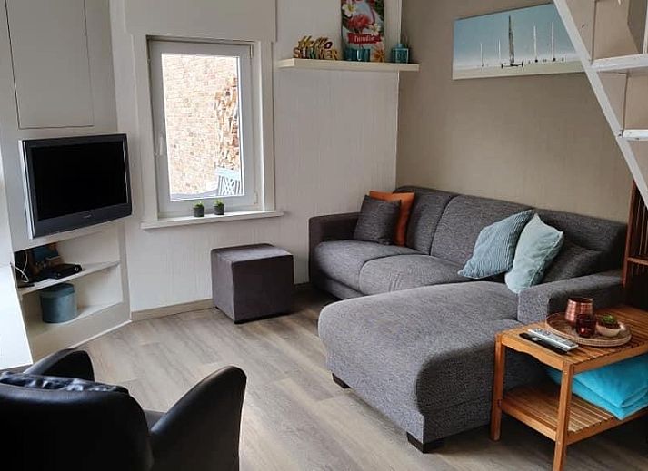 Ferienhaus La Casita in De Panne mit schoener Backsteinfassade und gruenen Blumenkaesten.
