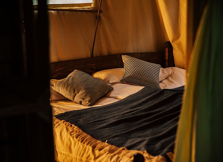Gezellige binnenruimte van Tenthuisje met warme privedouche in Zedelgem, West-Vlaanderen, Belgie. Geniet van glamping comfort in een rustieke setting.