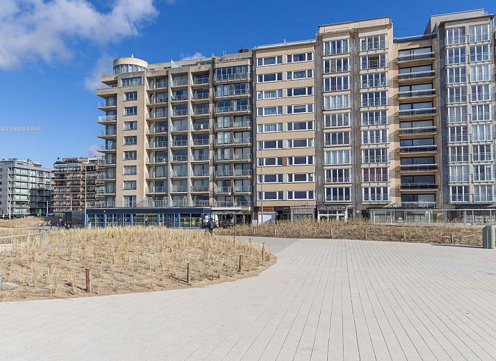 Helles Wohnzimmer im Azur Palace - 0602, Ferienhaus in Middelkerke, Westflandern, mit bequemen blauen Sofas und einer gemuetlichen Essecke.