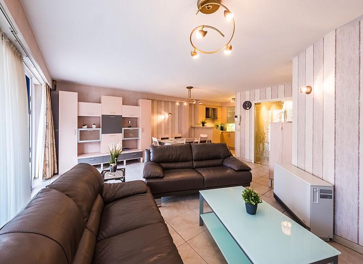 Gemuetliches Wohnzimmer im Ferienhaus Franklin - 0101, Middelkerke, mit geraeumiger Essecke und gemuetlicher Sitzecke am Fenster.