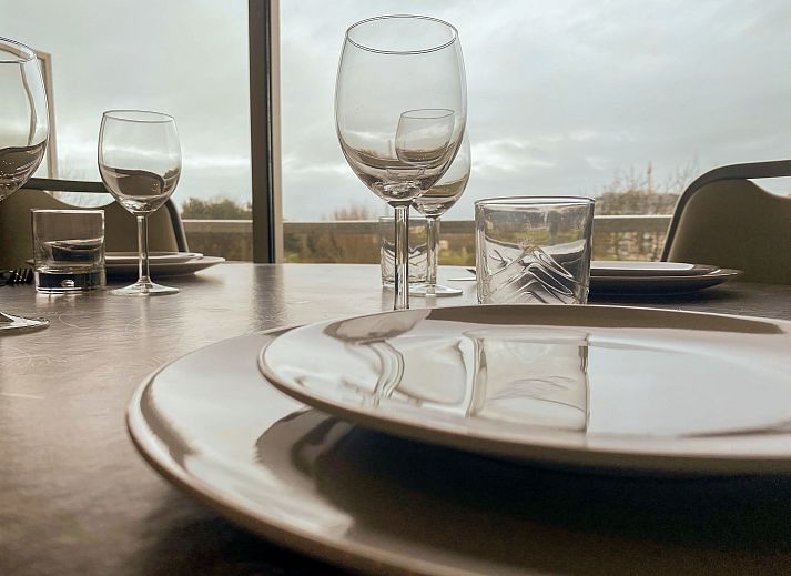 Moderne Kueche im Apartment Residentie Astrid, Bredene, Westflandern, Belgien, mit schlichten Schraenken und stimmungsvoller Beleuchtung.