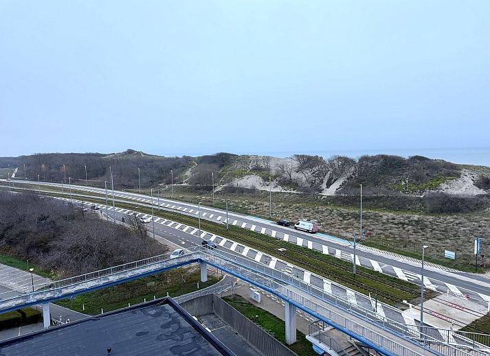 Helles Wohnzimmer des Apartment Studio 806 in Bredene, Westflandern, Belgien, mit Blick auf die Duenen vom Balkon aus.