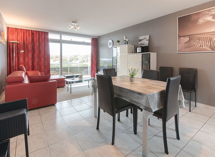 Stylish kitchen in Apartment Apt. 403, Bredene, West Flanders with modern red cabinets and a cozy bar area.