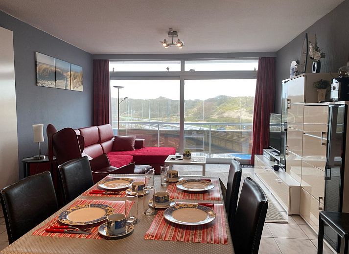 Stylish kitchen in Apartment Apt. 403, Bredene, West Flanders with modern red cabinets and a cozy bar area.