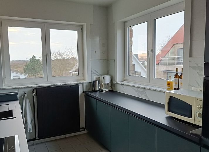 Papa's Dream vacation home in Oostduinkerke with stone facade and spacious driveway in West Flanders, Belgium.