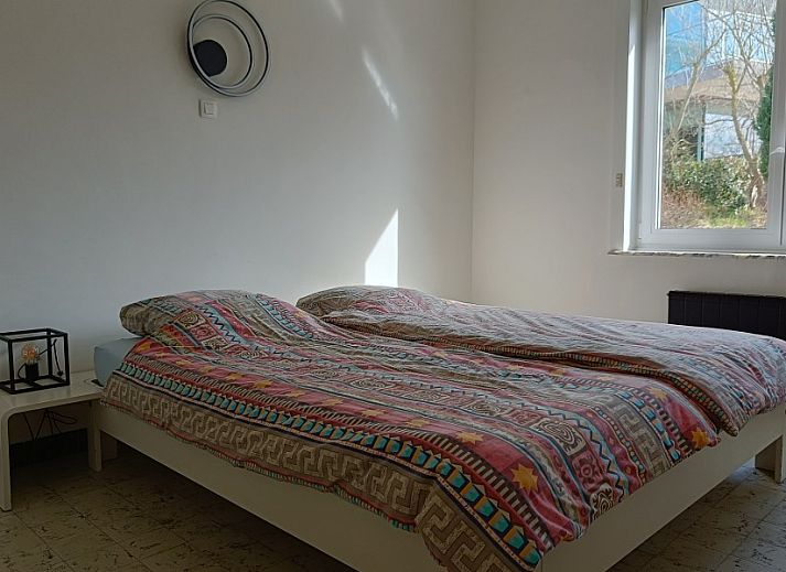 Stylish dining room in Papa's Dream vacation home, Oostduinkerke, with set table and modern furnishings.