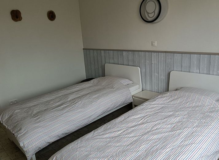 Stylish dining room in Papa's Dream vacation home, Oostduinkerke, with set table and modern furnishings.