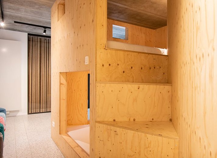 Modern bar in WOWie&Germain vacation home, Oostduinkerke, with stylish stools and playful decor.