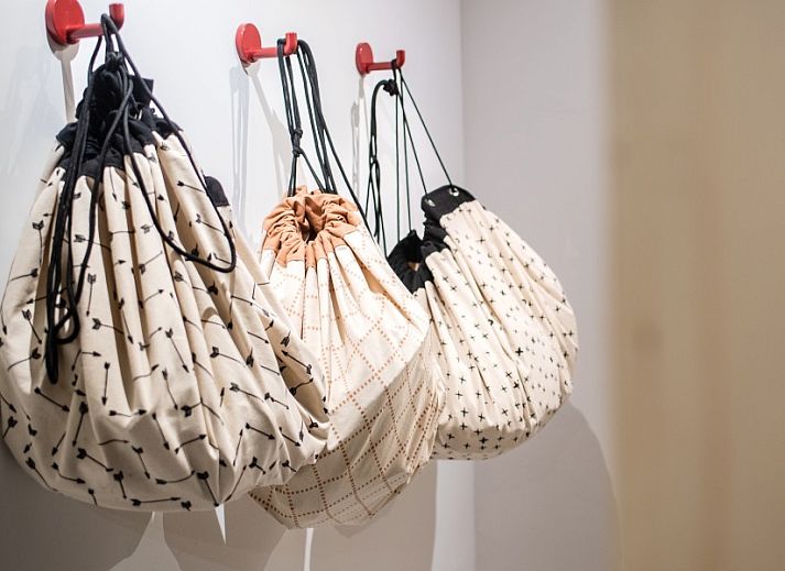 Cozy corner sofa in WOWie&Germain vacation home, Oostduinkerke, with retro wall decoration.