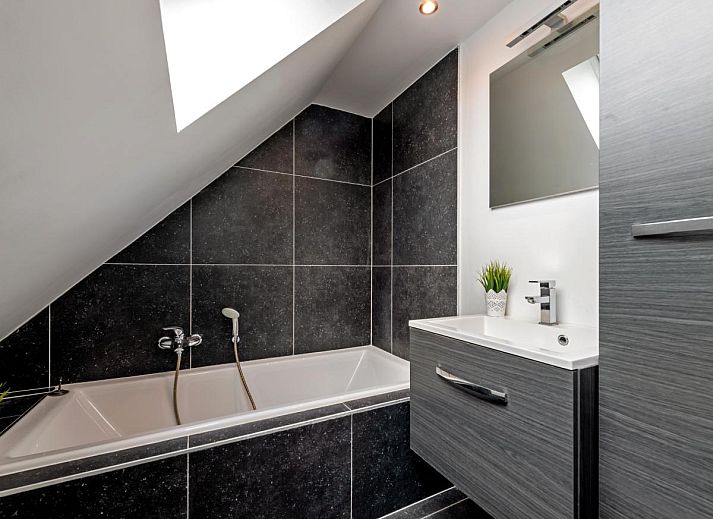 Gezellige woonkamer van Roborstje in Zwalm, Oost-Vlaanderen met kerstboom en uitzicht op de tuin.