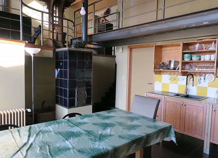 Dining room overlooking the garden in De Mutsaard, vacation home in the Flemish Ardennes, Belgium.