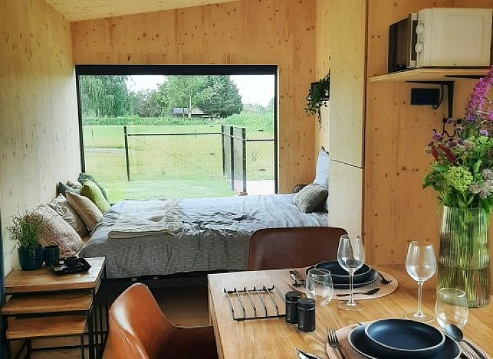 Black Pearl vacation home in Moerzeke, East Flanders, with sunny terrace and pond view.